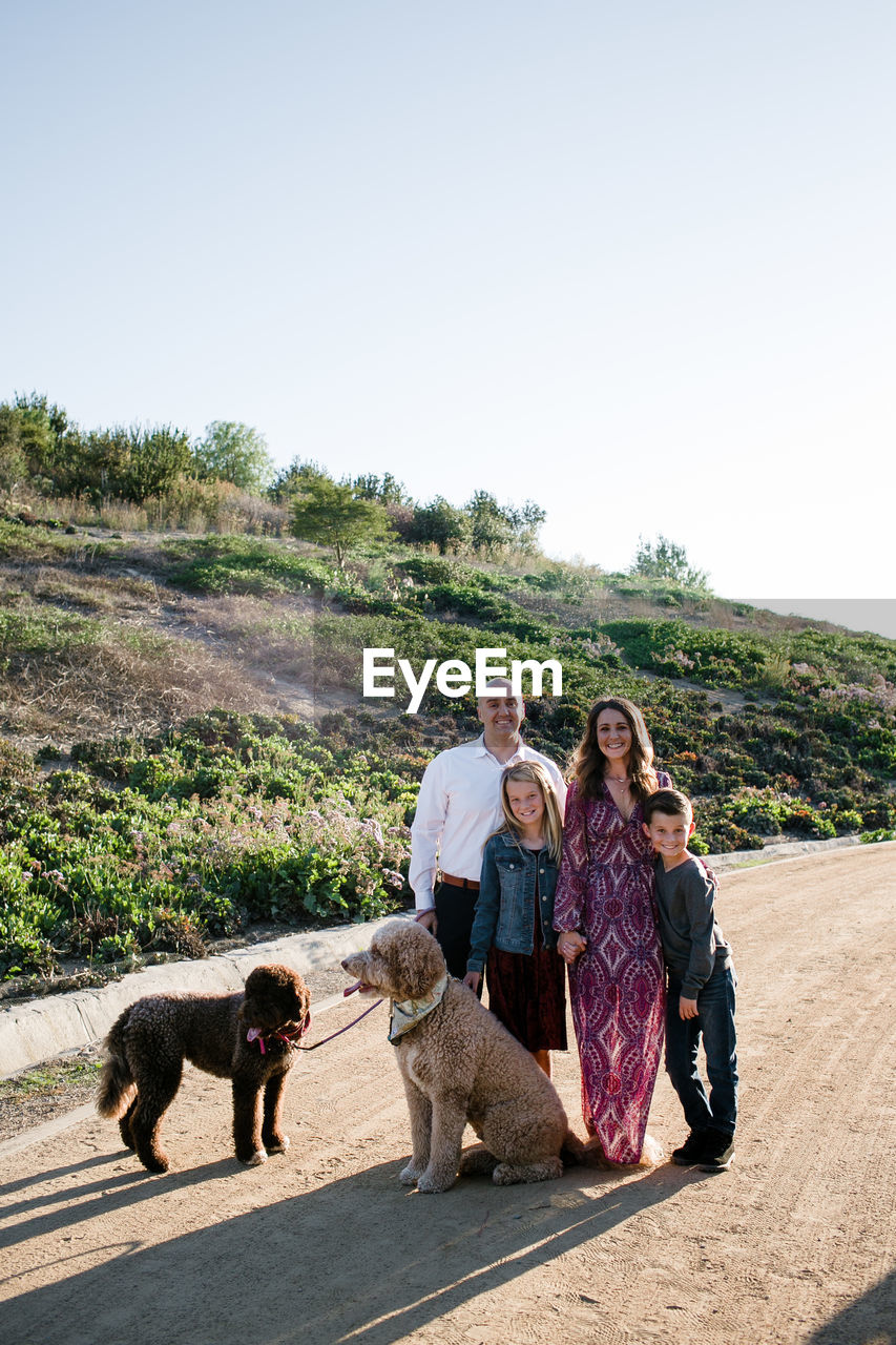 Family and dogs dressed up and posing for photos in southern californi