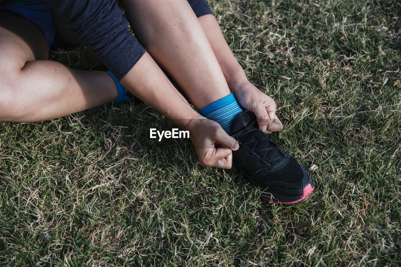 Girl tying her shoelaces before running