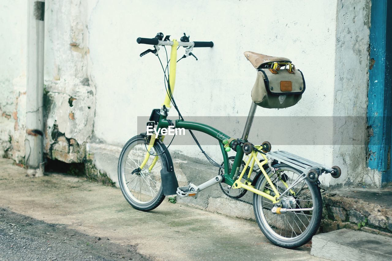 BICYCLES LEANING ON BICYCLE