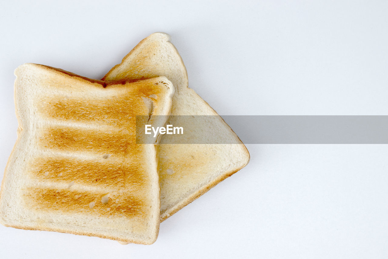 food, breakfast, dessert, baked, studio shot, toast, white background, dish, food and drink, bread, indoors, meal, toasted bread, sliced bread, cut out, no people, cuisine, snack, directly above, single object, copy space, high angle view, freshness, simplicity, still life