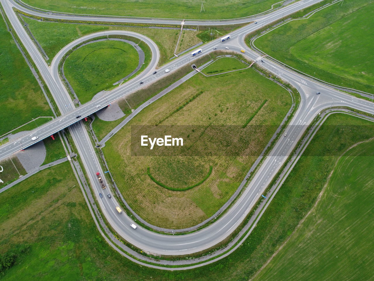 HIGH ANGLE VIEW OF ROAD AMIDST FIELD