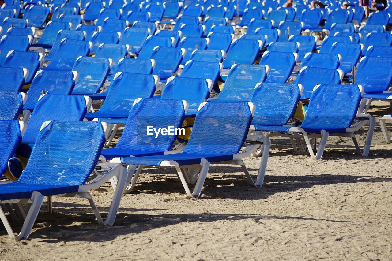 Empty blue chairs at beach