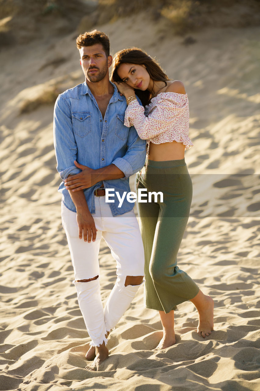 Young couple standing on beach