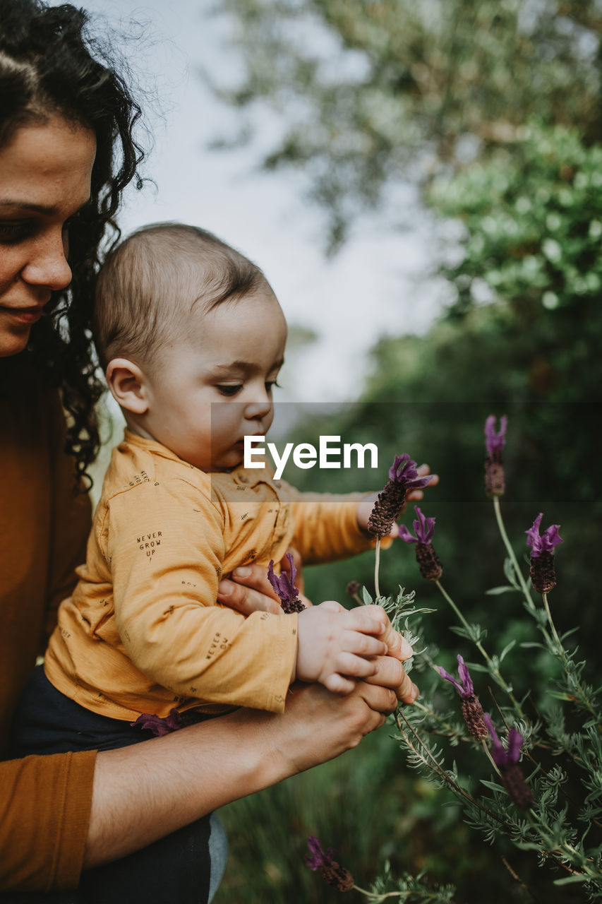 Woman with son looking at flowers