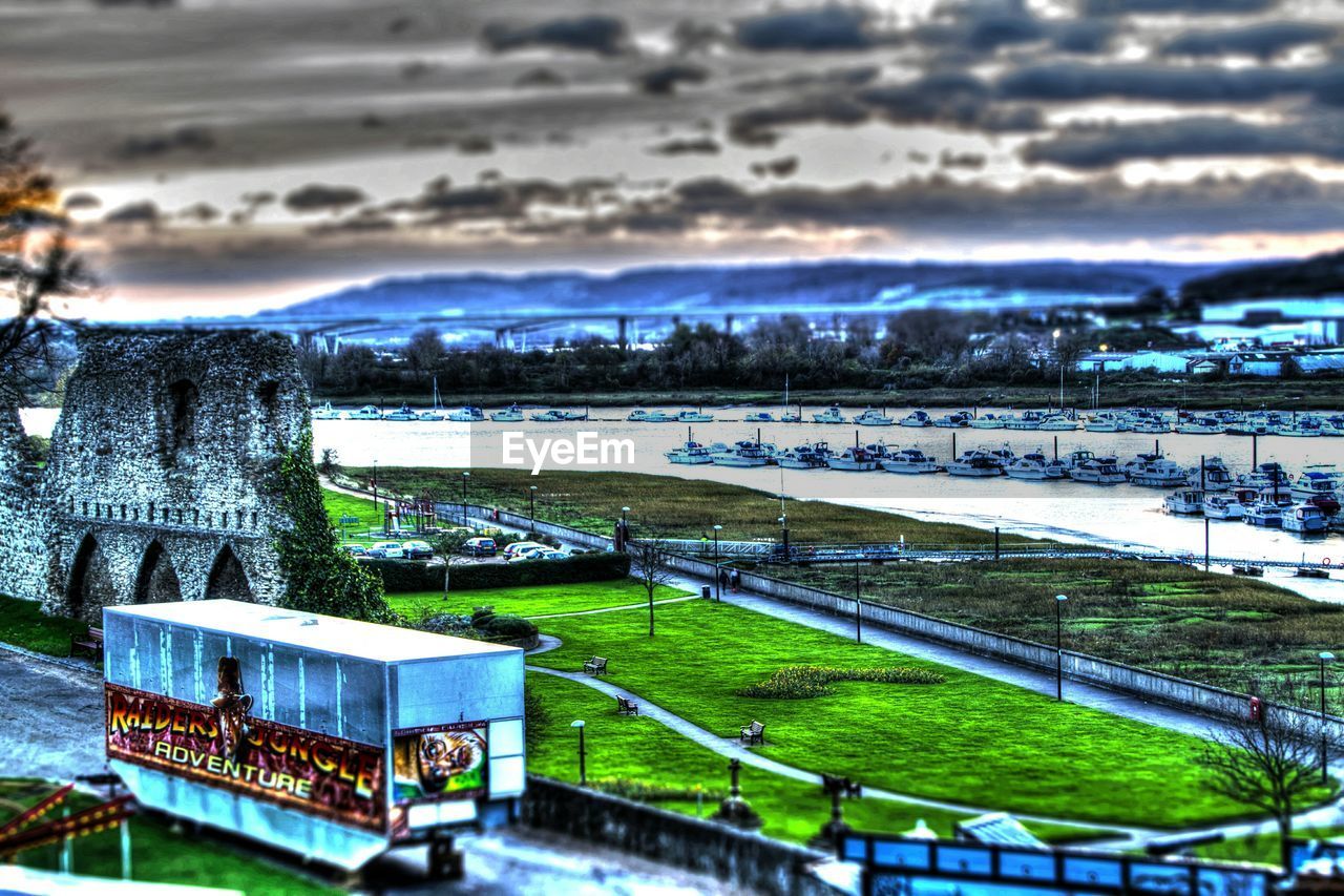 VIEW OF RIVER AGAINST CLOUDY SKY AT SUNSET