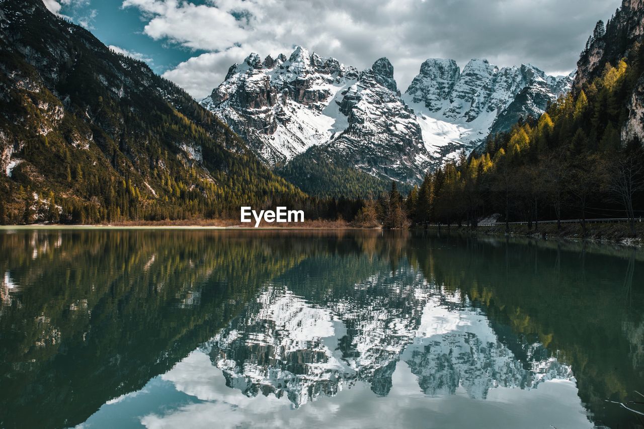 Scenic view of lake and snowcapped mountains against sky