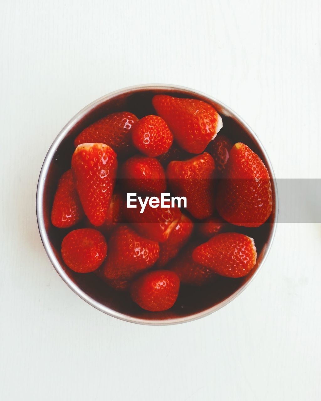 Directly above shot of strawberries in bowl on white background