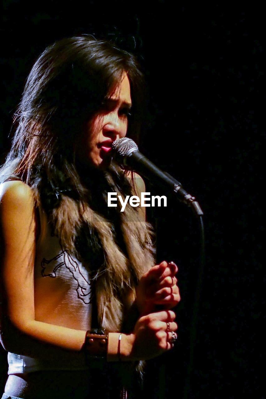 Young woman singing at nightclub