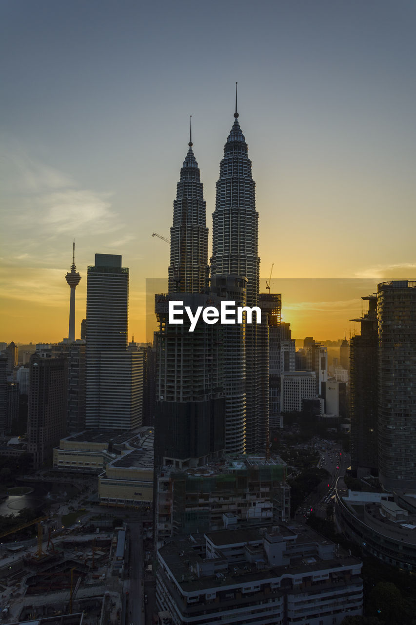 MODERN BUILDINGS AGAINST SKY DURING SUNSET