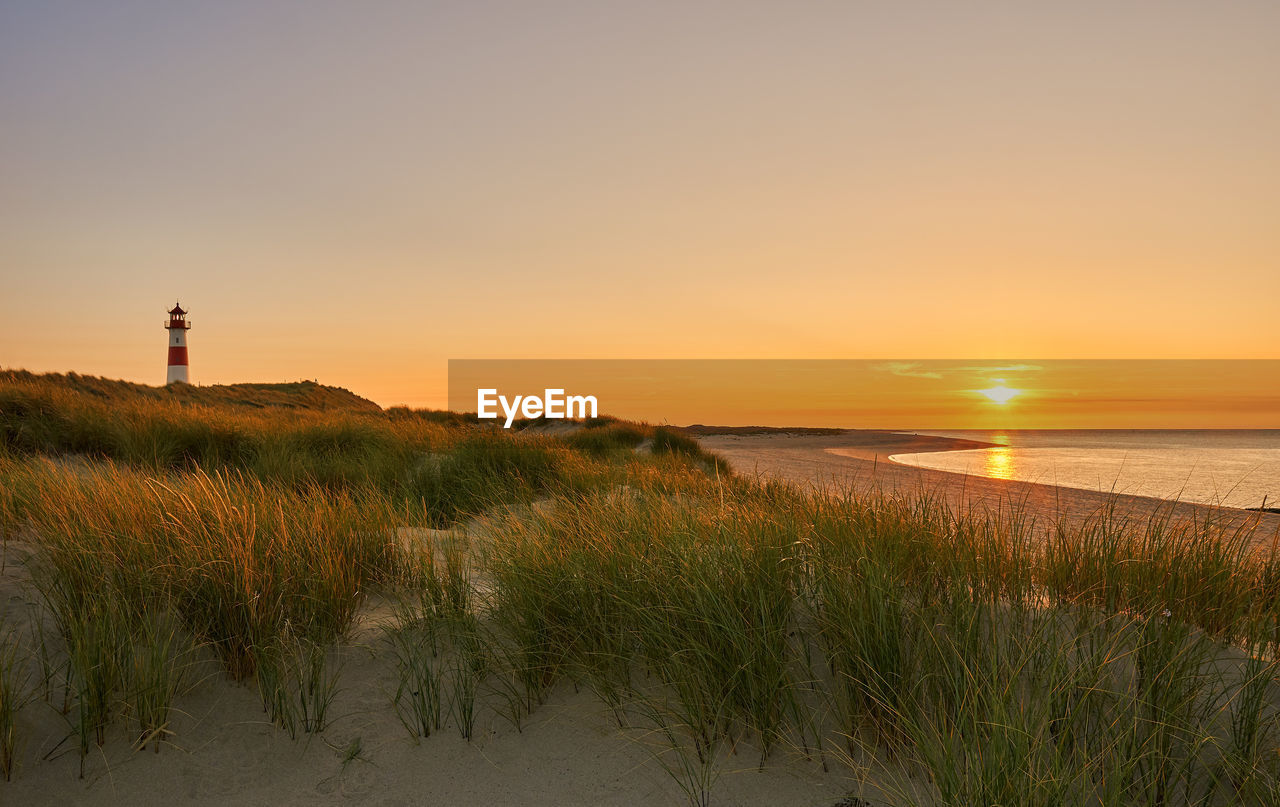 Scenic view of beach against sky during sunset