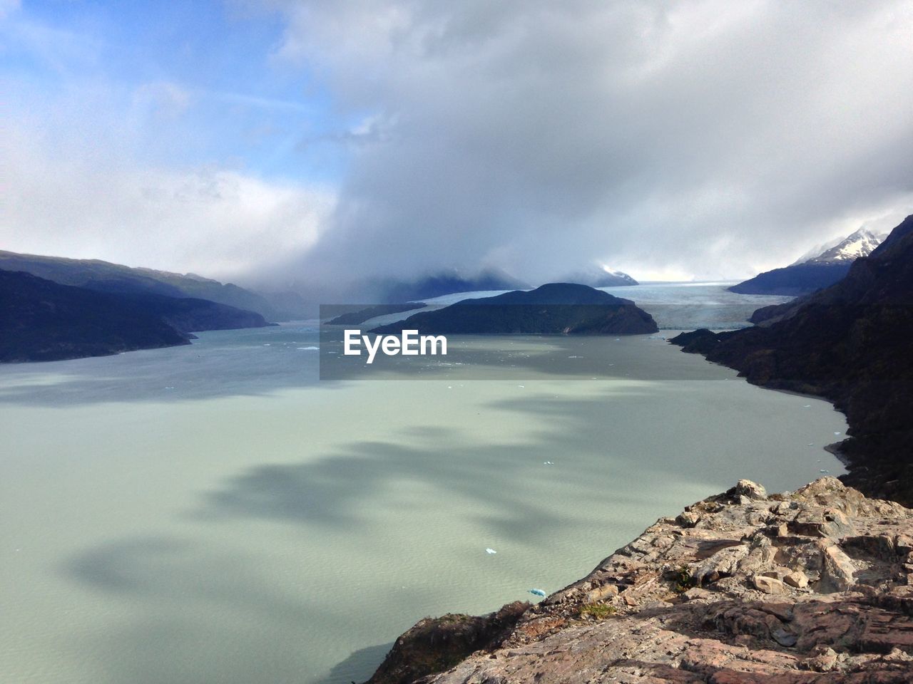 Beautiful alpine scenery with water and cloudy sky