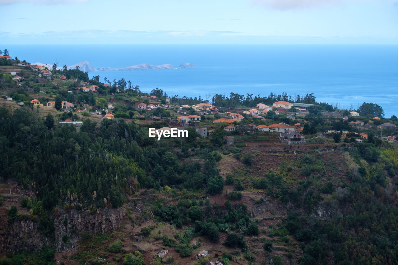 Panoramic view of townscape by sea against sky