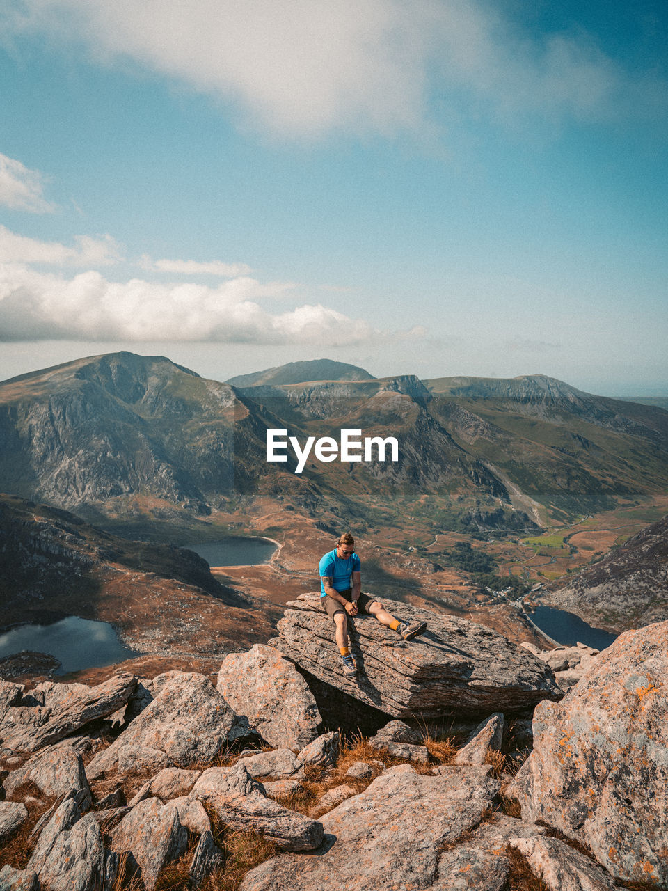 Man looking at mountain against sky