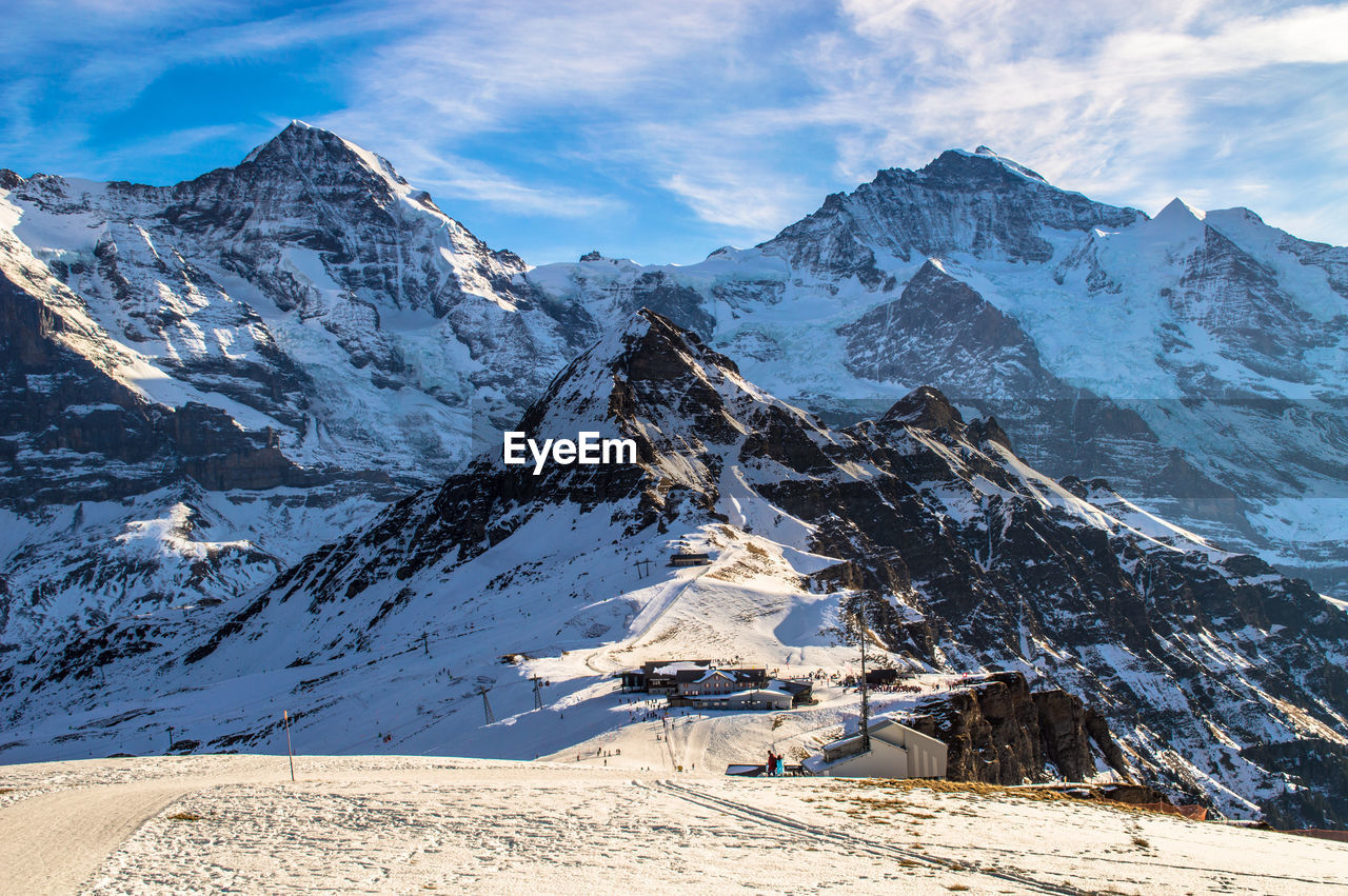 Scenic view of mountains against cloudy sky