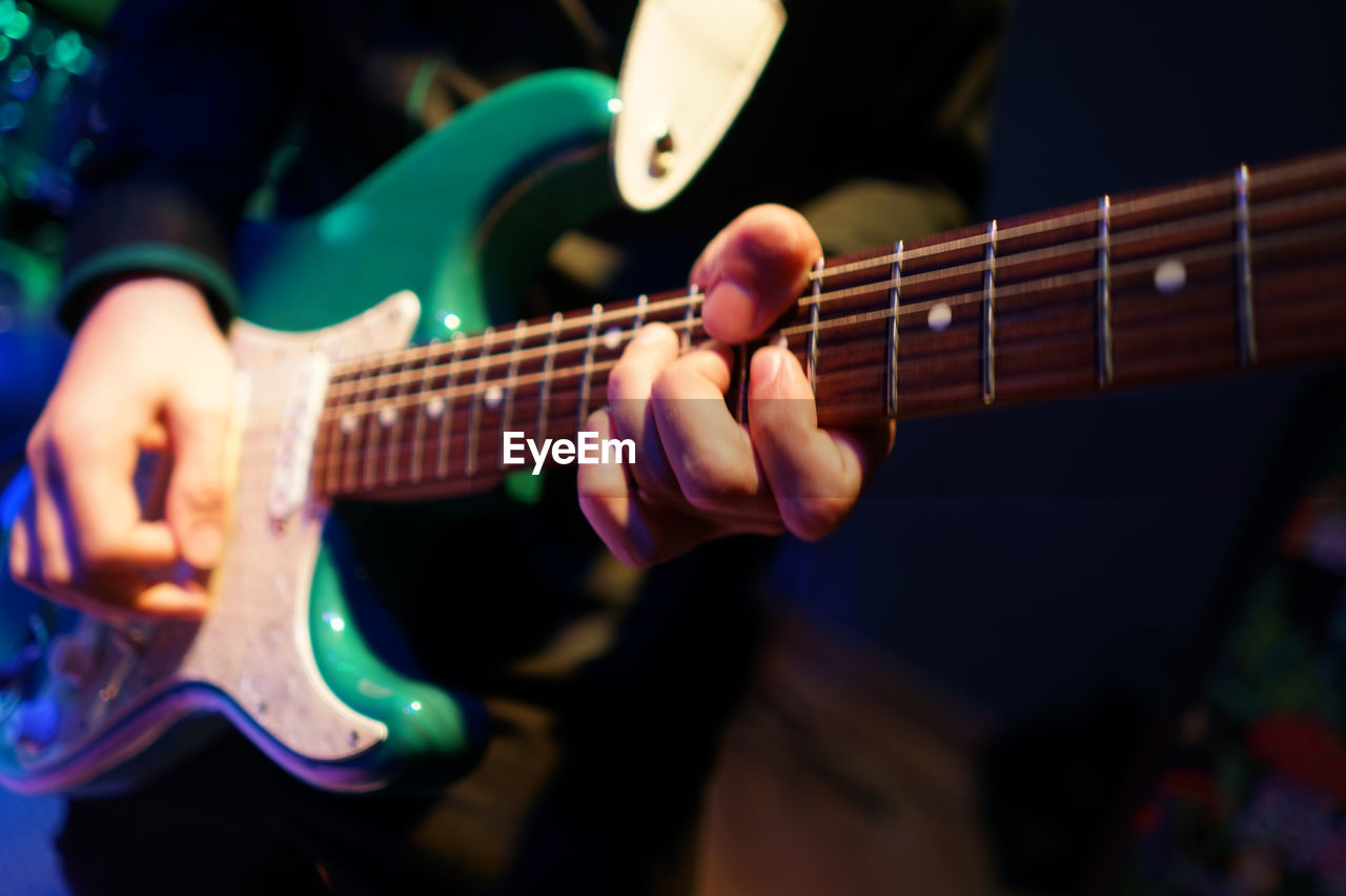 Close-up of man playing guitar