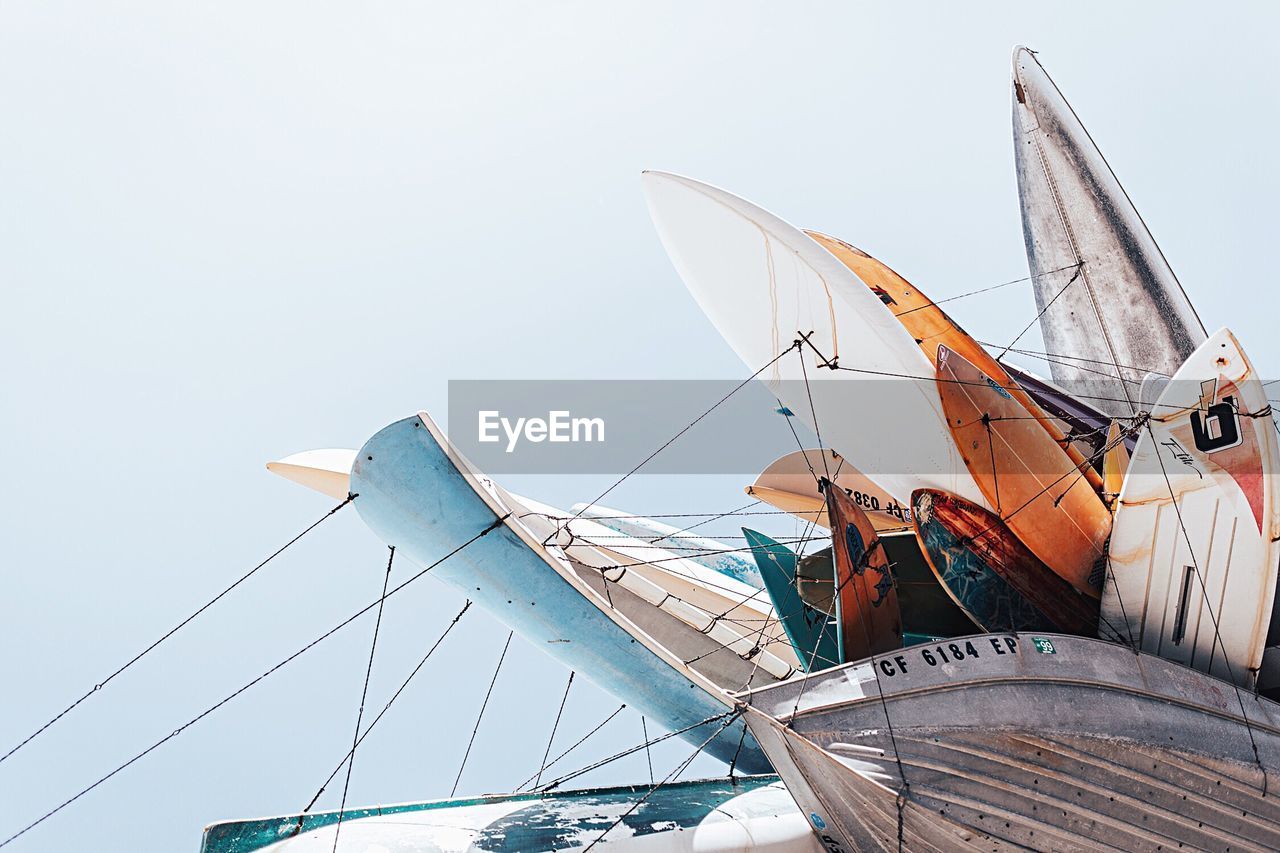 Low angle view of various boats against sky