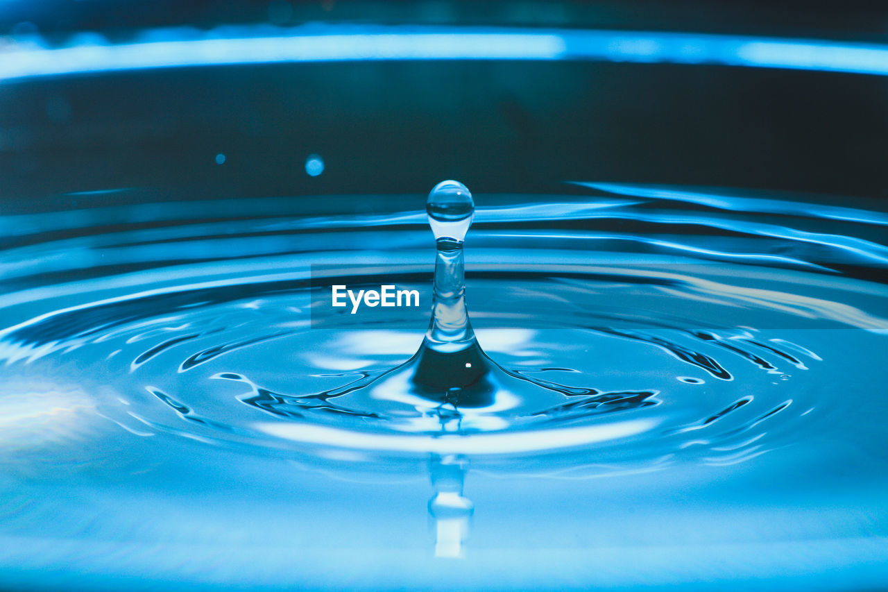 CLOSE-UP OF WATER SPLASHING IN BLUE SEA