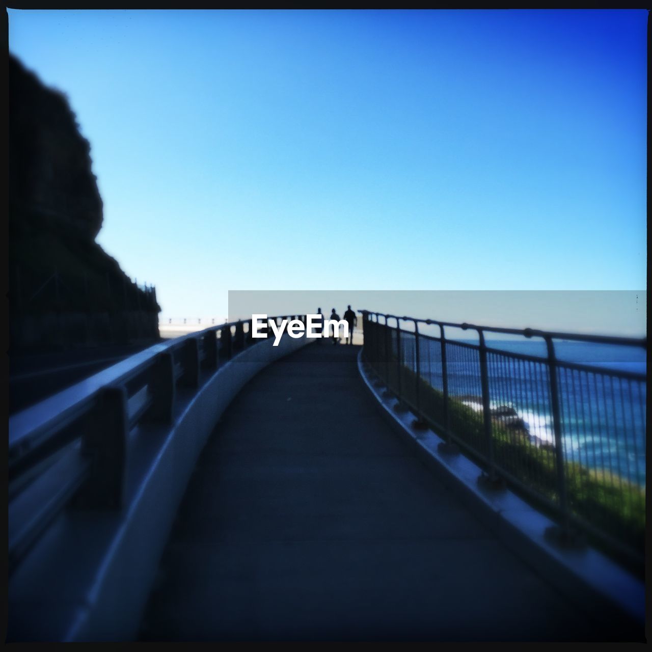 BRIDGE OVER RIVER AGAINST CLEAR SKY