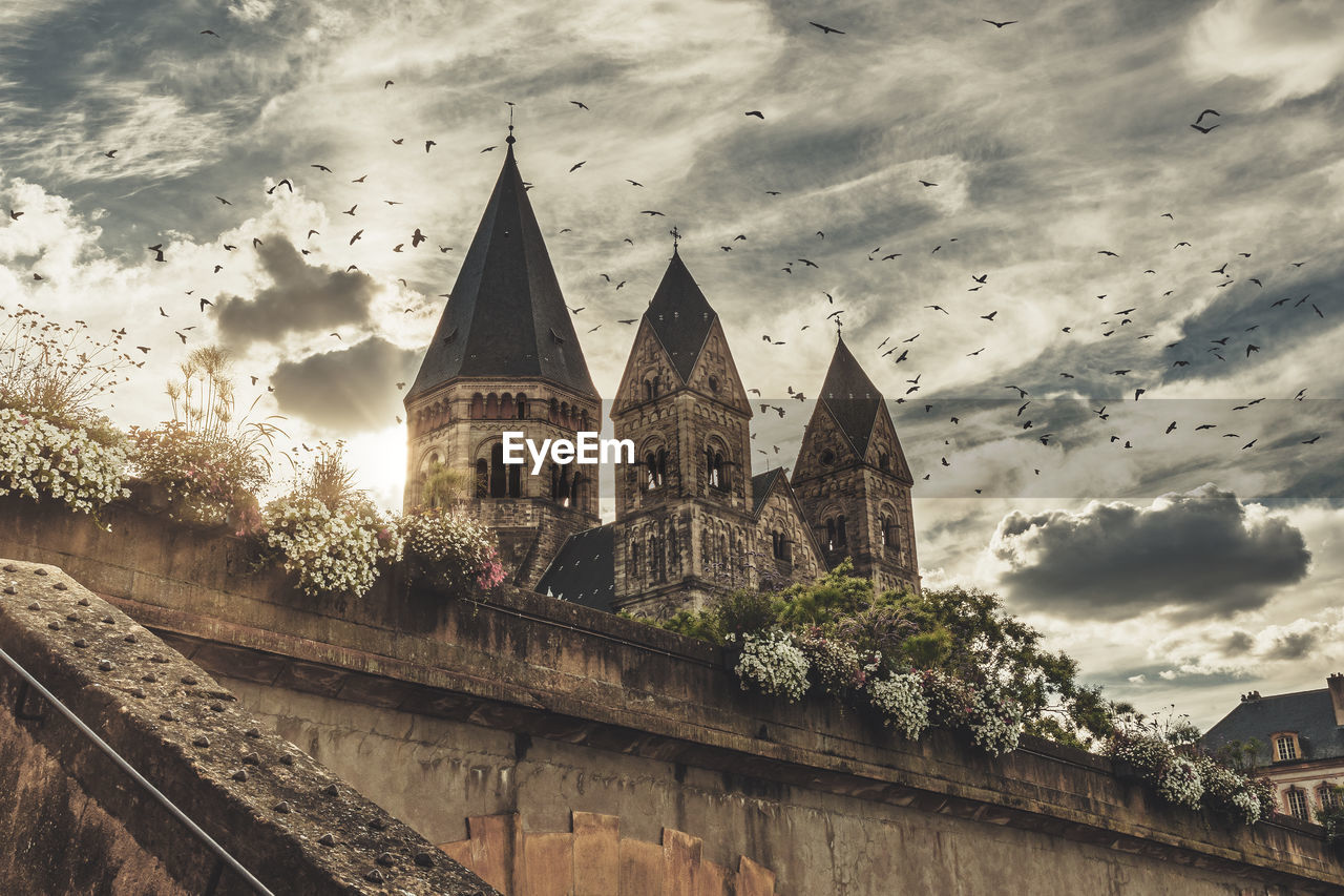 LOW ANGLE VIEW OF CATHEDRAL AGAINST SKY AND BUILDINGS