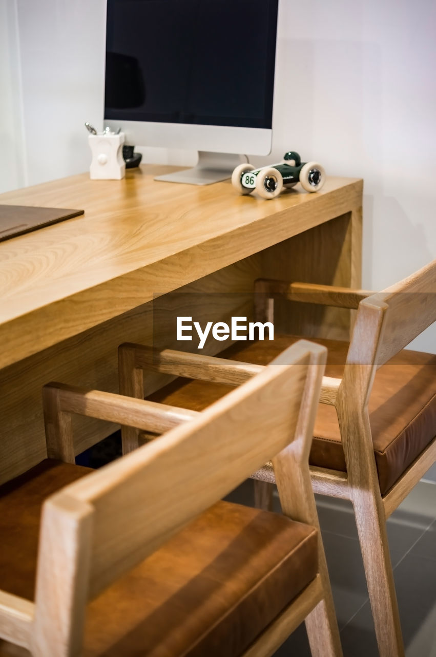 Ophthalmologist's office wooden consulting room with computer on the desk,