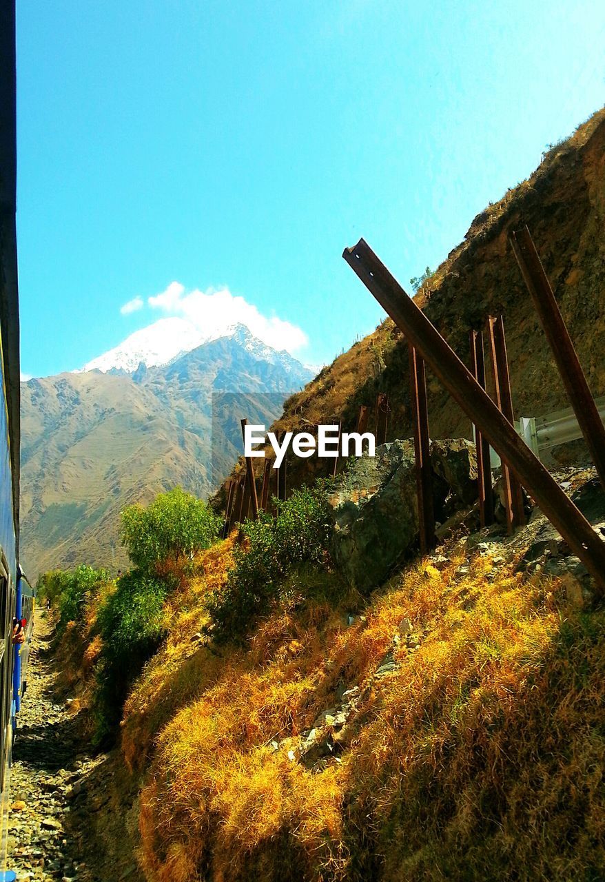 Scenic view of mountains against blue sky