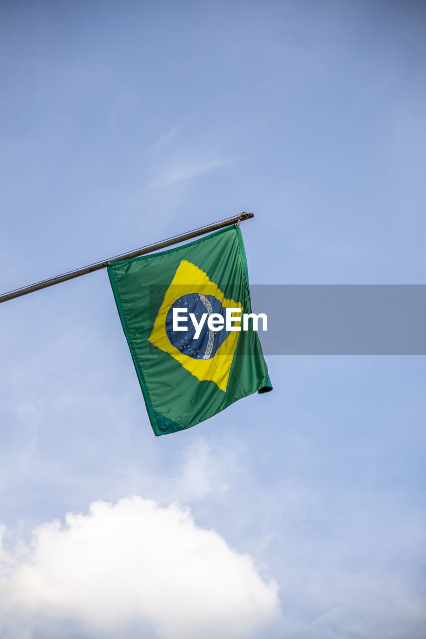 Low angle view of brazilian flag against sky.