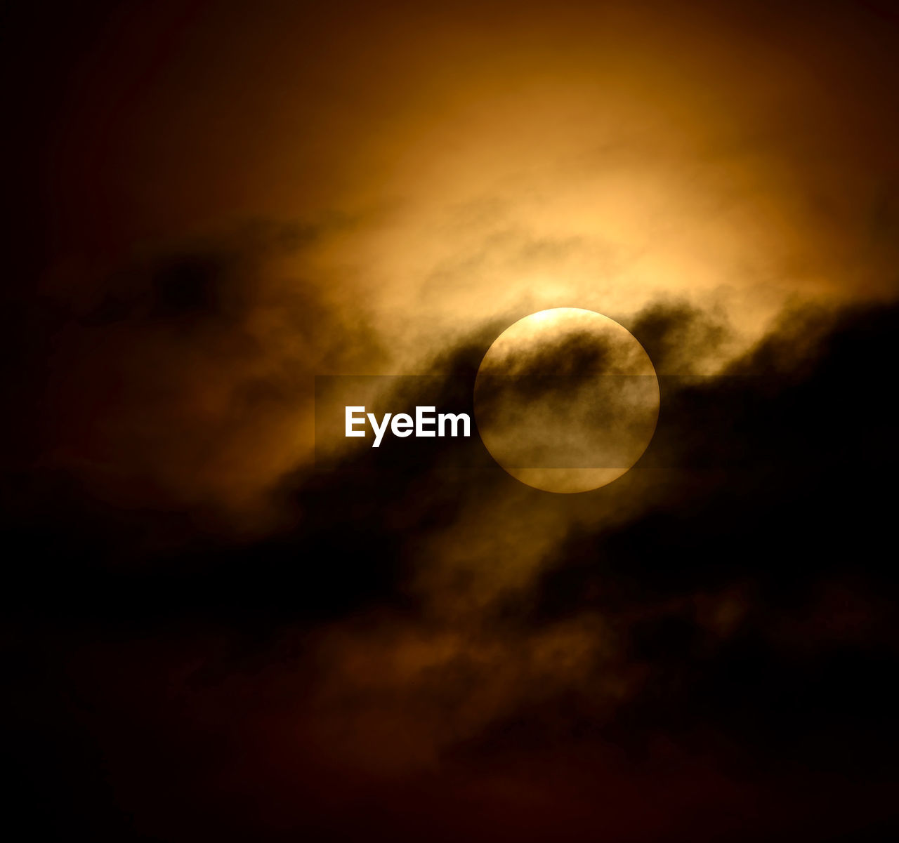 LOW ANGLE VIEW OF MOON AGAINST CLOUDS