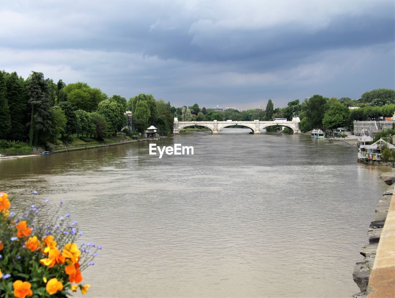 Scenic view of river by bridge against sky