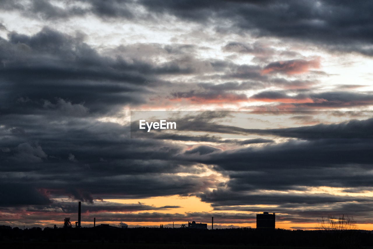 SILHOUETTE OF STORM CLOUDS OVER LANDSCAPE