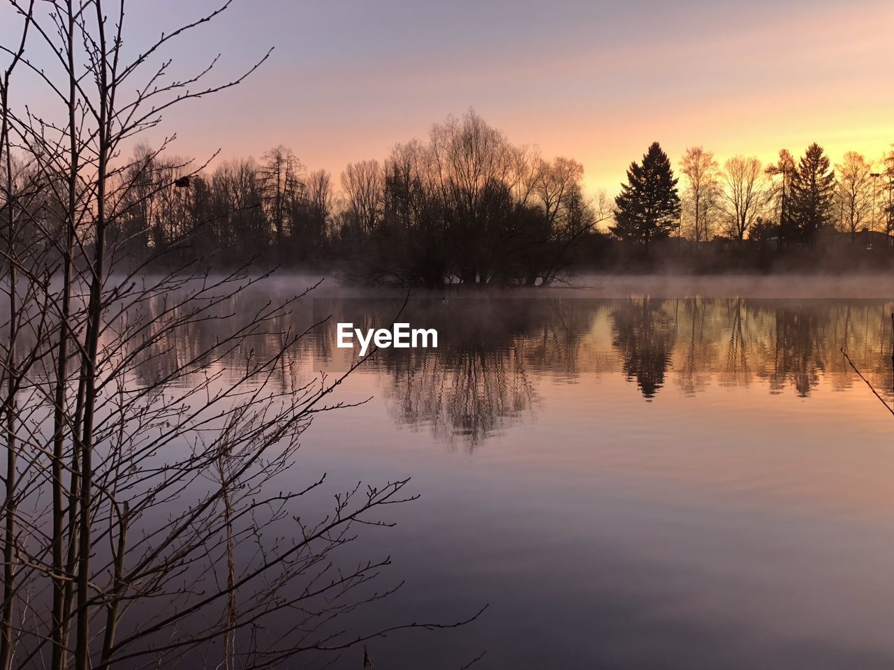 Scenic view of lake against sky during sunset