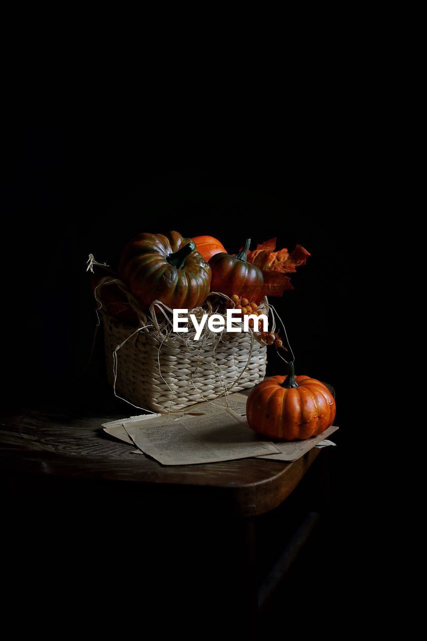 Close-up of pumpkin on table against black background