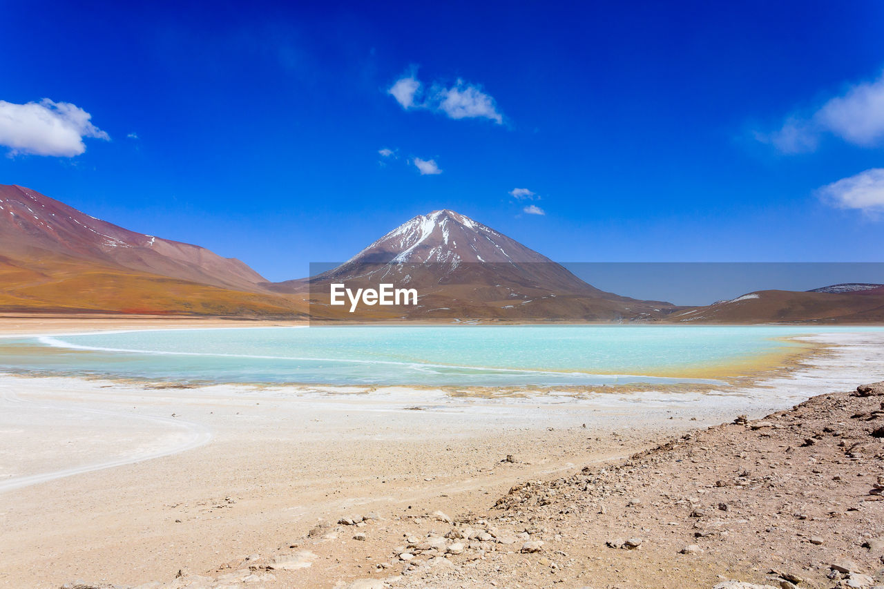 Scenic view of beach against blue sky