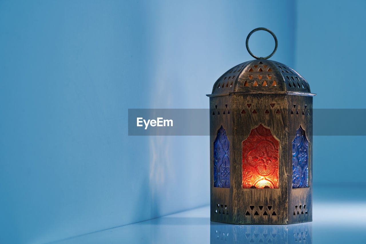 Ancient arabic lantern on blue background