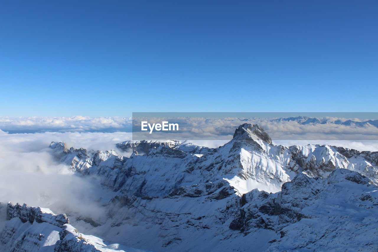 Aerial view of snowcapped mountains against sky