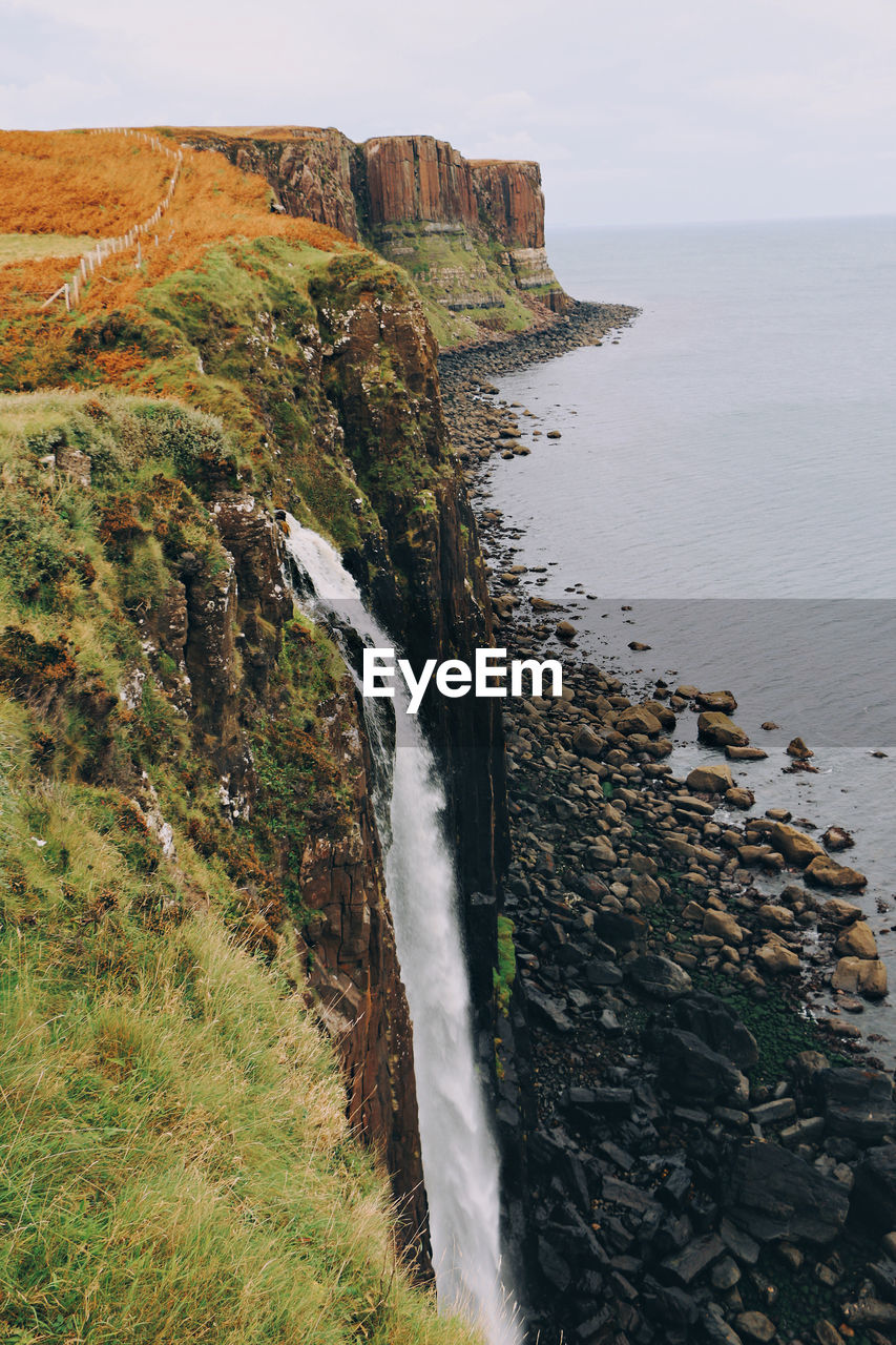 Scenic view of waterfalls from the cliffs into the sea 