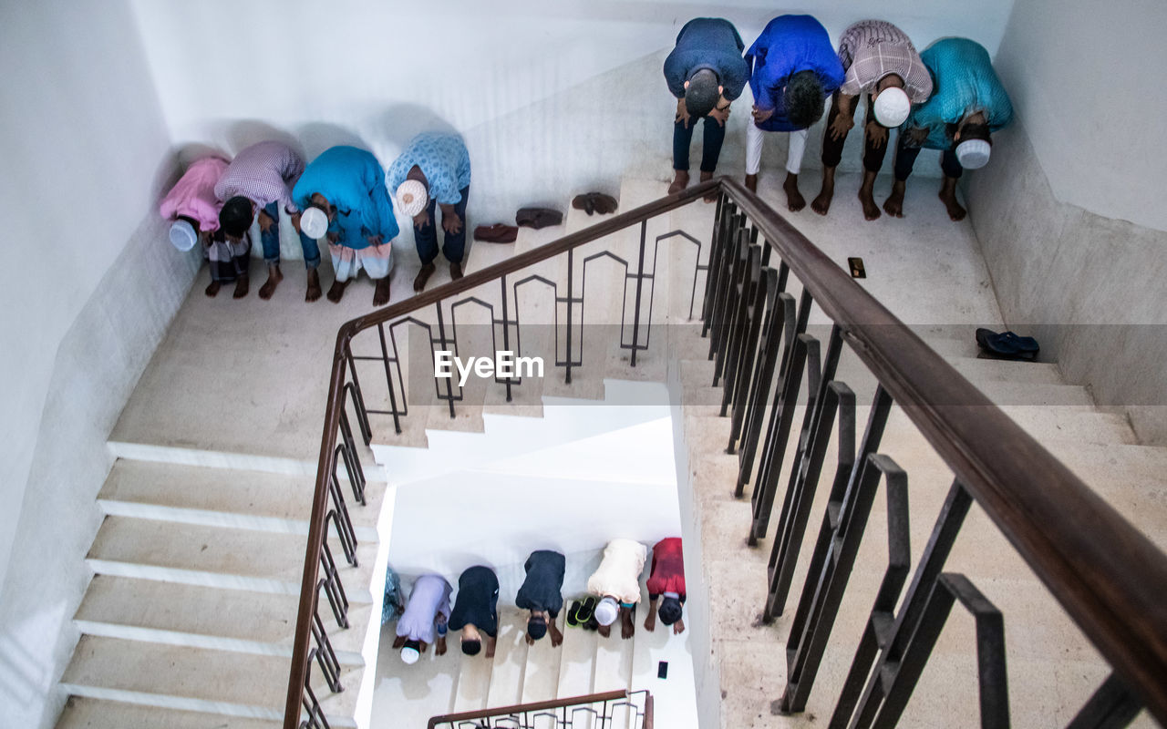 High angle view of people walking on staircase