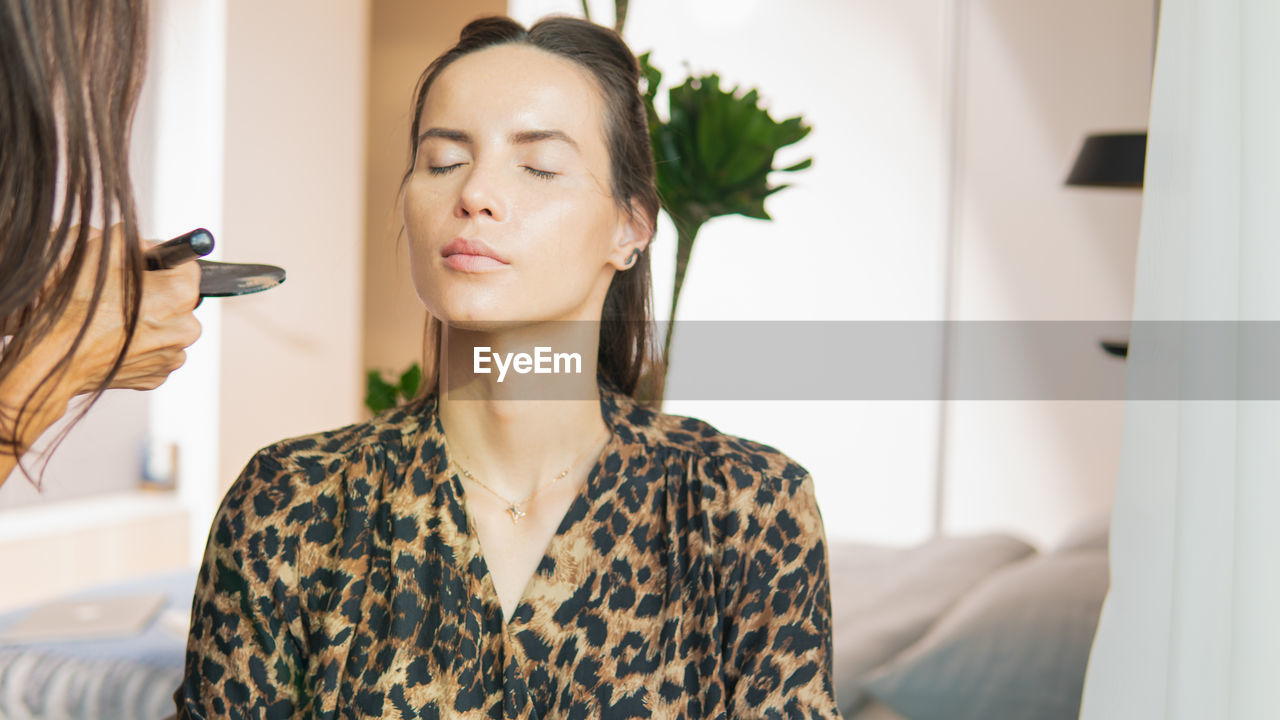 PORTRAIT OF YOUNG WOMAN LOOKING AT CAMERA