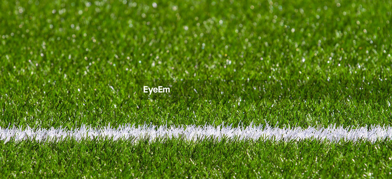 Full frame shot of soccer field with white marking