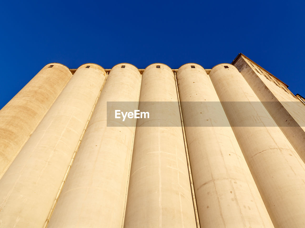 Low angle view of building against clear blue sky