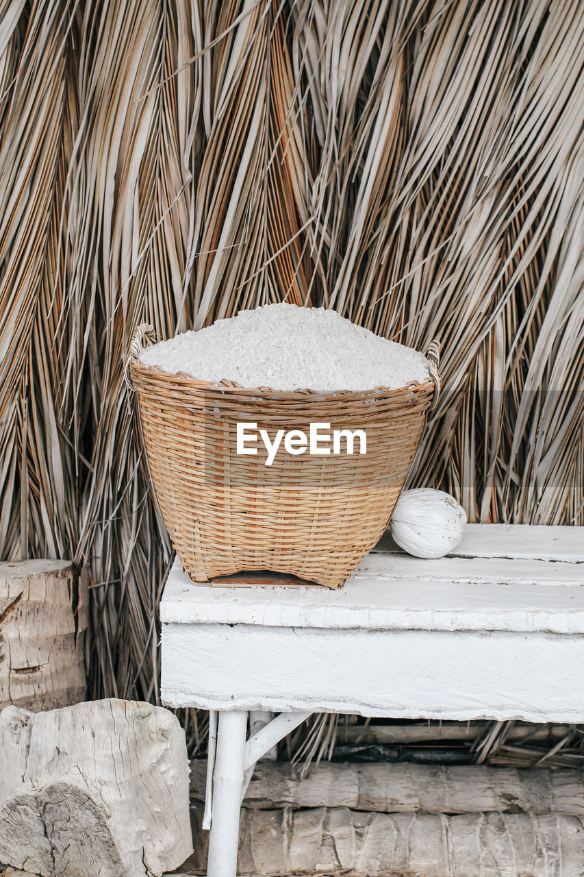 CLOSE-UP OF WICKER BASKET ON TABLE