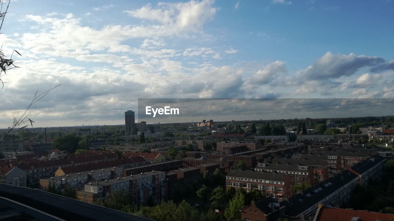 Cityscape against cloudy sky