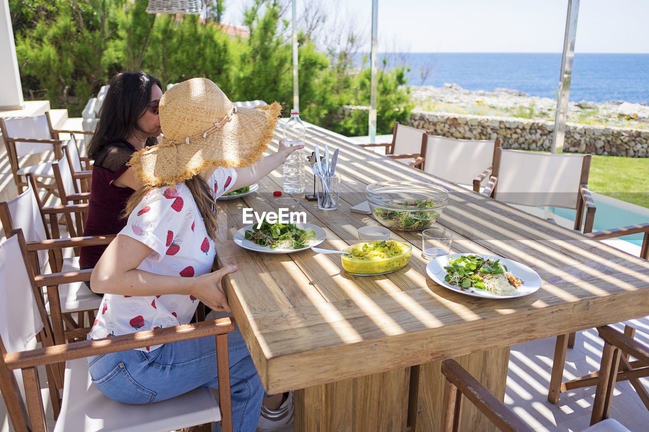 PEOPLE ON TABLE AT SEA SHORE