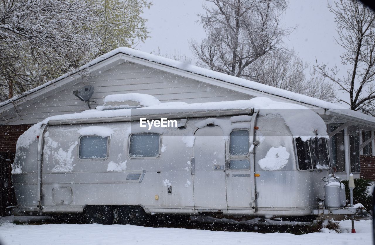 CLOSE-UP OF CARS ON SNOW COVERED CAR