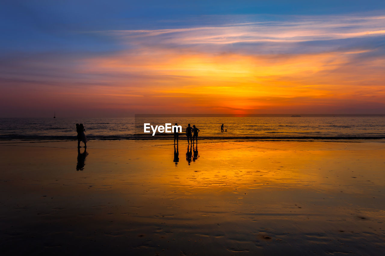 PEOPLE ON BEACH DURING SUNSET