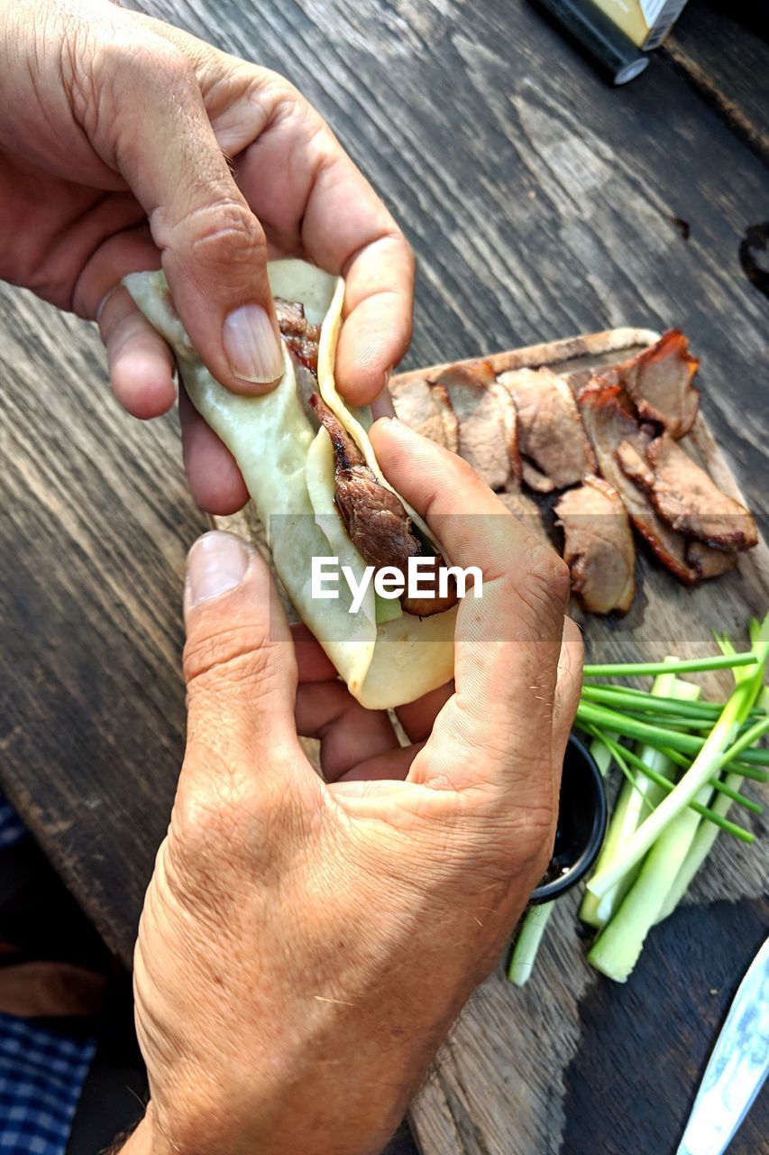 High angle view of man preparing food on table