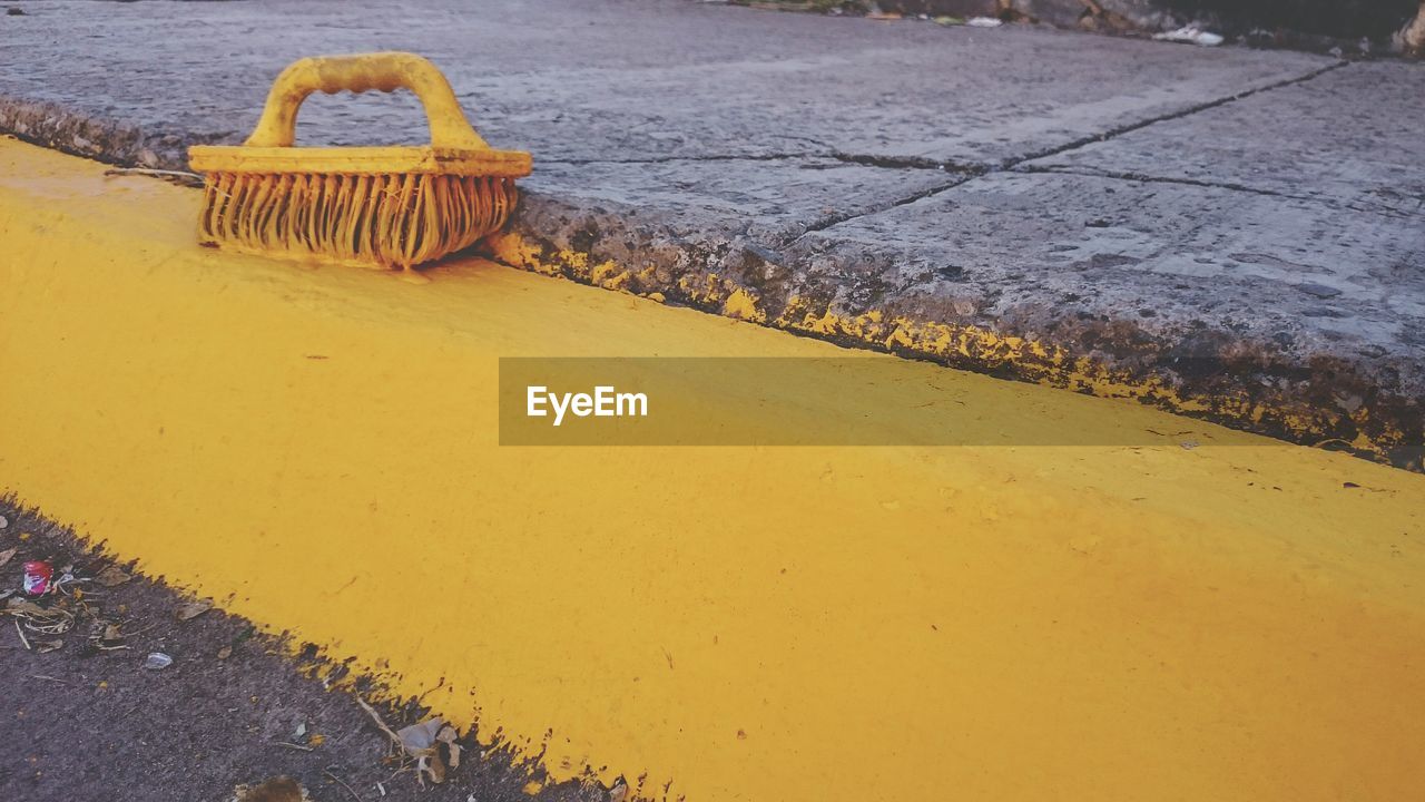 High angle view of street painted with yellow color