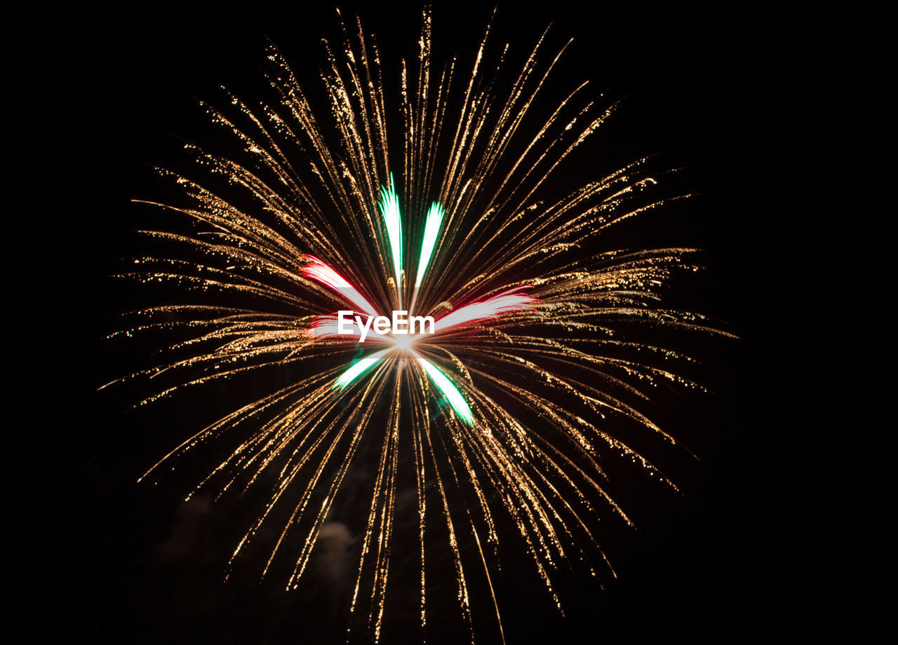 Low angle view of firework display at night