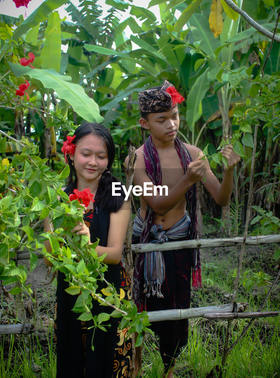 A girl and boy is feeling happy to take care the plants