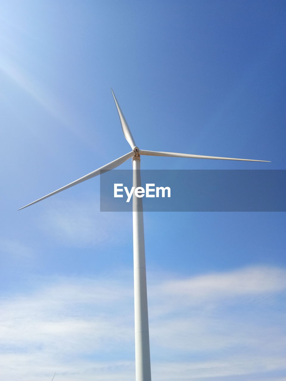 LOW ANGLE VIEW OF WINDMILL AGAINST BLUE SKY