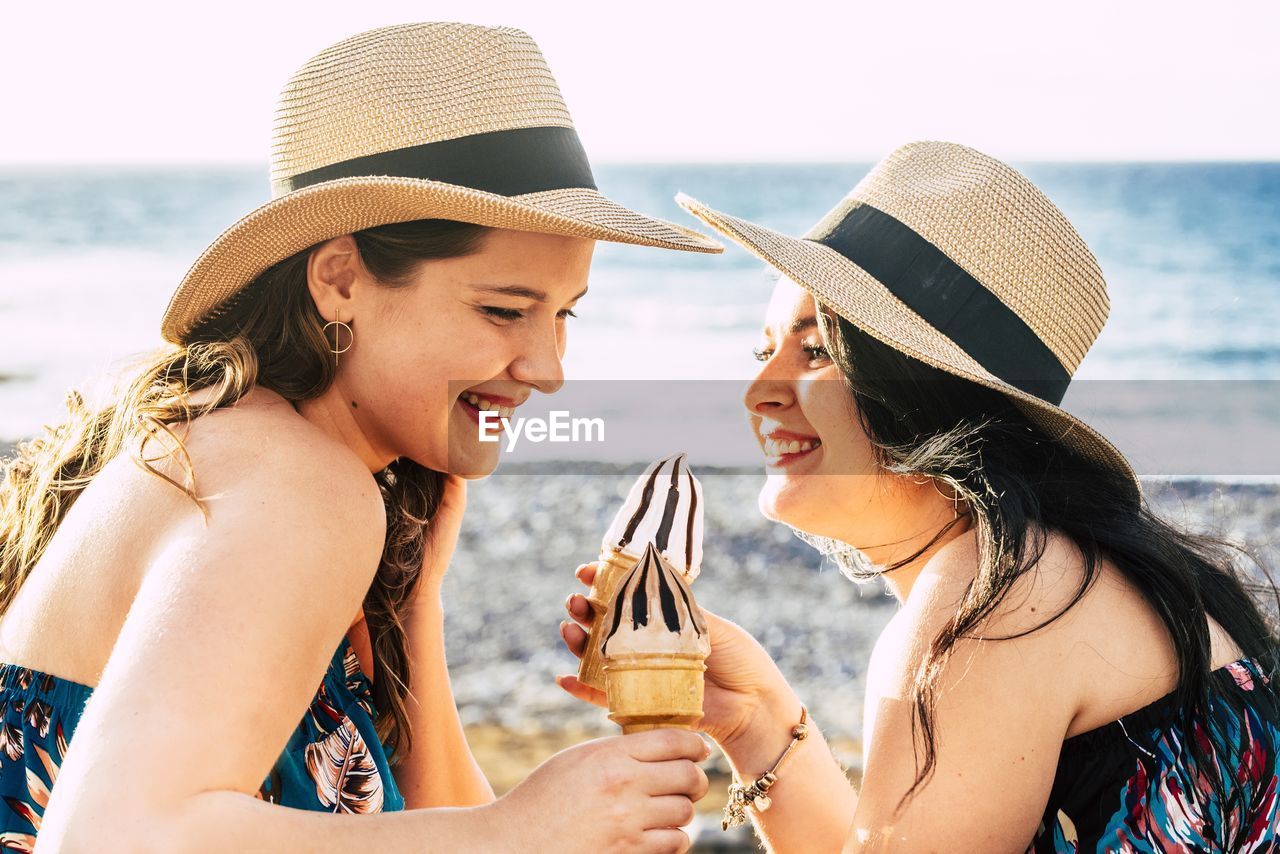 Young woman wearing hat on beach